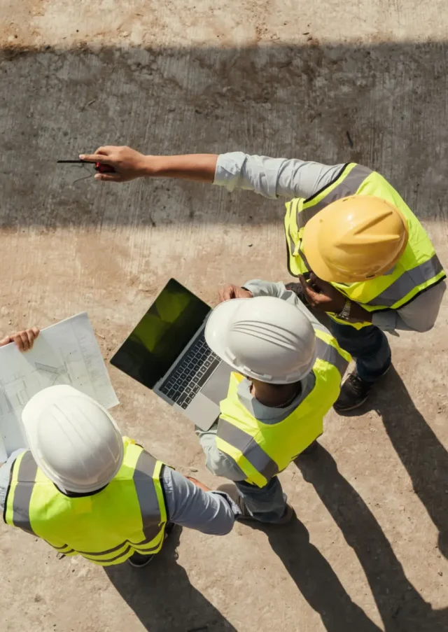 Top view, Team engineer building inspection use tablet computer and blueprint working at construction site. Civil Engineer, Contractor and Architect discussing in construction site.